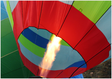Balloon inflation, with blast of heat from burner.