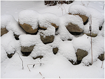Stone wall with new snow.